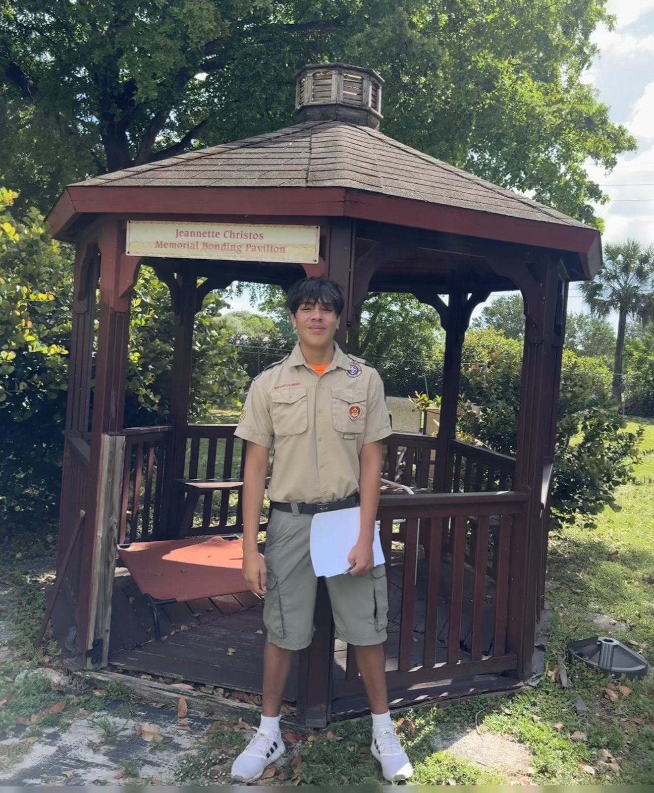 Jack in his Scout uniform beside the Jeanette Christos Memorial Bonding Pavilion
